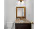 Elegant bathroom featuring a granite countertop, framed mirror, and classic fixtures at 10865 Misty Moon Ct, Alpharetta, GA 30022