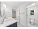 A well lit bathroom with double sinks, a separate toilet, and a view into the bedroom at 10865 Misty Moon Ct, Alpharetta, GA 30022