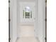 Bright bathroom showcasing a soaking tub, white tile, and a large window with a view at 10865 Misty Moon Ct, Alpharetta, GA 30022