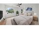 Bright, minimalist bedroom featuring a large window, ceiling fan and a plush headboard at 10865 Misty Moon Ct, Alpharetta, GA 30022