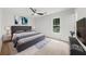 Cozy bedroom featuring hardwood floors, soft lighting, and a large window with a scenic view at 10865 Misty Moon Ct, Alpharetta, GA 30022