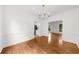 Bright dining room featuring wood floors, white walls, and elegant trim at 10865 Misty Moon Ct, Alpharetta, GA 30022