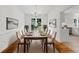 Elegant dining room featuring hardwood floors, a modern chandelier and ample seating for eight at 10865 Misty Moon Ct, Alpharetta, GA 30022