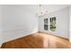 Dining room with hardwood floors, a modern chandelier, and a large window at 10865 Misty Moon Ct, Alpharetta, GA 30022