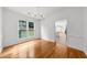 Dining room with hardwood floors, white walls, and a modern chandelier at 10865 Misty Moon Ct, Alpharetta, GA 30022
