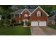 Charming two-story brick home with a well-manicured lawn and a two-car garage at 10865 Misty Moon Ct, Alpharetta, GA 30022