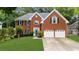 Charming two-story brick home with a well-manicured lawn and a two-car garage at 10865 Misty Moon Ct, Alpharetta, GA 30022