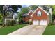 Charming two-story brick home with a well-manicured lawn and a two-car garage at 10865 Misty Moon Ct, Alpharetta, GA 30022