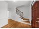 Inviting foyer with hardwood floors, staircase with decorative iron spindles, and a freshly painted interior at 10865 Misty Moon Ct, Alpharetta, GA 30022