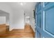 Welcoming foyer with hardwood flooring, a staircase, and a blue front door to the property at 10865 Misty Moon Ct, Alpharetta, GA 30022