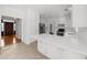 Open-concept kitchen featuring white cabinets, stainless steel appliances, and a tile floor at 10865 Misty Moon Ct, Alpharetta, GA 30022