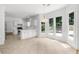 Sunlit breakfast nook and kitchen with white cabinets and large windows at 10865 Misty Moon Ct, Alpharetta, GA 30022