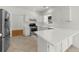 Kitchen boasting white cabinets, modern appliances, and a breakfast bar at 10865 Misty Moon Ct, Alpharetta, GA 30022