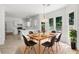 Cozy eat-in kitchen with tile flooring, white cabinets, stainless steel appliances and natural light at 10865 Misty Moon Ct, Alpharetta, GA 30022