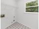 A clean laundry room with vinyl floor and a wire shelf for organized storage at 10865 Misty Moon Ct, Alpharetta, GA 30022
