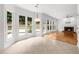 Bright living room with fireplace, hardwood floors, and multiple windows with outdoor views at 10865 Misty Moon Ct, Alpharetta, GA 30022