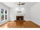 Bright living room with bamboo flooring and brick fireplace, offering a cozy and inviting atmosphere at 10865 Misty Moon Ct, Alpharetta, GA 30022