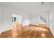 Spacious living room features hardwood floors and a view of the staircase, with white paint throughout at 10865 Misty Moon Ct, Alpharetta, GA 30022