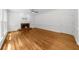 Living room featuring bamboo flooring and a brick fireplace with white mantle at 10865 Misty Moon Ct, Alpharetta, GA 30022