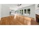 Spacious living room featuring hardwood floors, a fireplace, and large windows with a backyard view at 10865 Misty Moon Ct, Alpharetta, GA 30022