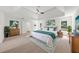 Spacious main bedroom with a tray ceiling, neutral decor, and a ceiling fan for added comfort at 10865 Misty Moon Ct, Alpharetta, GA 30022