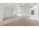 Large main bedroom with tray ceiling, ceiling fan and exterior window view at 10865 Misty Moon Ct, Alpharetta, GA 30022