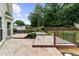 Multi-tiered backyard patio features decorative planters and black metal railings at 10865 Misty Moon Ct, Alpharetta, GA 30022