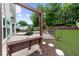 A relaxing backyard patio featuring a charming porch swing and landscaped garden at 10865 Misty Moon Ct, Alpharetta, GA 30022