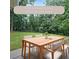 Outdoor patio features an outdoor dining table and chairs surrounded by mature trees at 1850 Donald Dr, Marietta, GA 30062