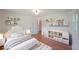 Bright bedroom with a twin bed, wall shelves, and a changing table for an organized space at 1850 Donald Dr, Marietta, GA 30062