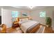 Cozy bedroom featuring a queen-sized bed, hardwood floors, and natural light from two windows at 1850 Donald Dr, Marietta, GA 30062