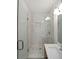 Bathroom featuring tiled walk-in shower with glass doors and chrome fixtures at 1850 Donald Dr, Marietta, GA 30062