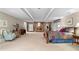 Spacious basement with a stone fireplace, neutral color palette, and carpet flooring at 217 Millbrook Farm Rd, Marietta, GA 30068