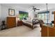 Bright bedroom with neutral walls, a ceiling fan, and a large window with views of the surrounding greenery at 217 Millbrook Farm Rd, Marietta, GA 30068