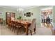 Dining room with long wooden table, chandelier and light green walls, with view into a seating area at 217 Millbrook Farm Rd, Marietta, GA 30068