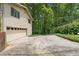 Attached garage and driveway with ample parking space, surrounded by mature trees at 217 Millbrook Farm Rd, Marietta, GA 30068