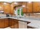The kitchen features granite countertops, wood cabinets, and stainless steel appliances for modern cooking at 217 Millbrook Farm Rd, Marietta, GA 30068