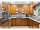 Well-equipped kitchen featuring stainless steel appliances, granite countertops, and wood cabinets at 217 Millbrook Farm Rd, Marietta, GA 30068