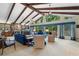 Bright living room with vaulted ceilings, exposed beams, stone fireplace, and large windows at 217 Millbrook Farm Rd, Marietta, GA 30068