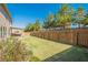 Large, manicured lawn is bordered by a wooden fence, offering privacy and ample space for outdoor activities at 2235 Well Springs Dr Dr, Buford, GA 30519