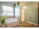 Bright bathroom features a garden tub, large glass shower, and decorative ceiling at 2235 Well Springs Dr Dr, Buford, GA 30519