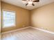 Bright, empty bedroom with wood laminate flooring, one window, and neutral paint at 2235 Well Springs Dr Dr, Buford, GA 30519