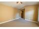 Cozy carpeted bedroom with a ceiling fan and a doorway leading to another room at 2235 Well Springs Dr Dr, Buford, GA 30519