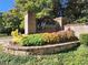 Welcoming community entrance sign enhanced with colorful landscaping and stone accents at 2235 Well Springs Dr Dr, Buford, GA 30519