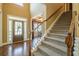Grand foyer featuring hardwood floors, staircase with carpet runner, and high ceilings for an open feel at 2235 Well Springs Dr Dr, Buford, GA 30519