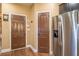 Hallway featuring wood flooring, a stainless steel refrigerator, and two doors at 2235 Well Springs Dr Dr, Buford, GA 30519