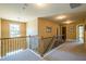 Upstairs hallway featuring carpeted floors, neutral walls, and wood railing at 2235 Well Springs Dr Dr, Buford, GA 30519
