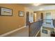 Carpeted upstairs hallway with wood railing and multiple access doors to bedrooms at 2235 Well Springs Dr Dr, Buford, GA 30519