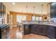 Contemporary kitchen with granite counters, stainless appliances, breakfast bar, and wood floors at 2235 Well Springs Dr Dr, Buford, GA 30519