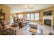 Comfortable living area with fireplace, neutral walls, tile floors, and large windows at 2235 Well Springs Dr Dr, Buford, GA 30519